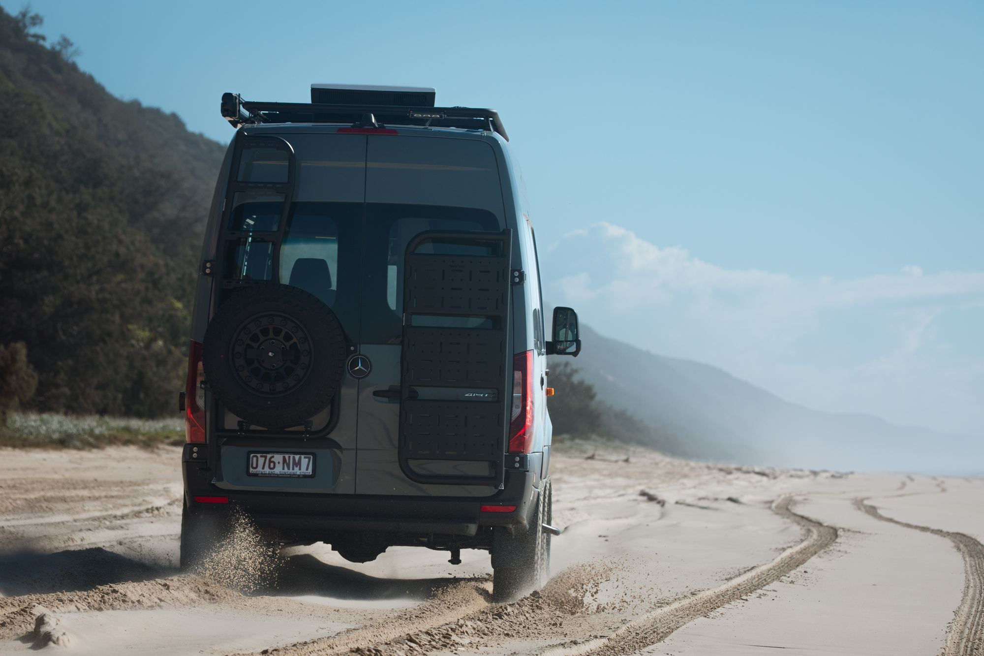 A Hinter Vans Sprinter driving away along the beach